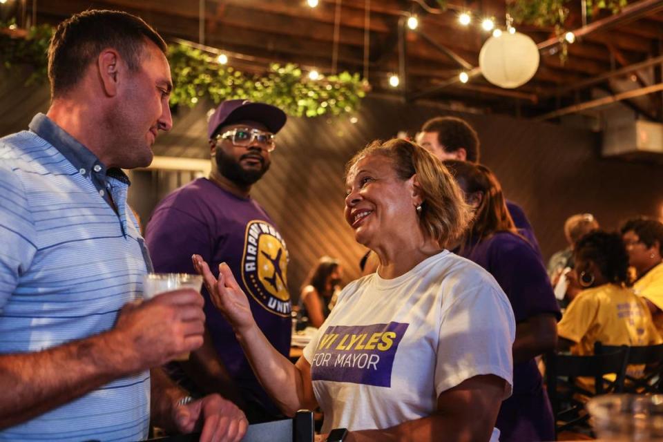 Mayor Vi Lyles, left, speaks with a supporter a post-election watch party at Heist Brewery on Tuesday, July 26, 2022 in Charlotte, NC.