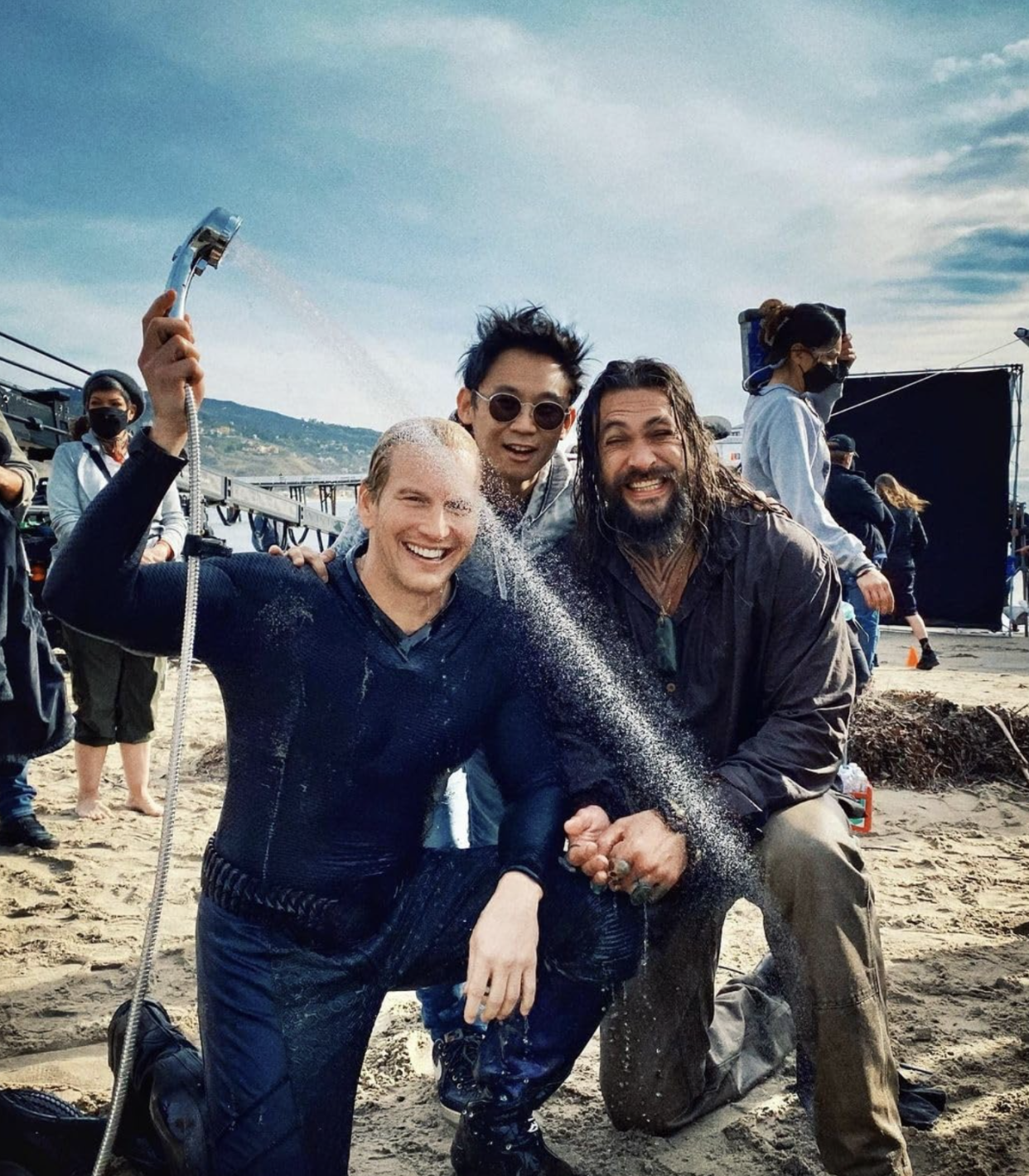 Patrick Wilson, James Wan and Jason Momoa celebrate the end of the shoot on the beach in Malibu. (Warner Bros./Atomic Monster/DC Studios)