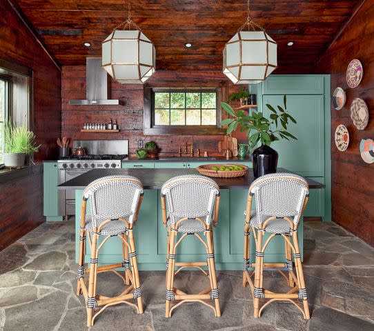 Photography by Brian Woodcock; Styling by Natalie Warady The property’s largest cabin, The Kingfisher (kitchen pictured), was relocated to Flat Mountain Farm from Burlington, North Carolina.