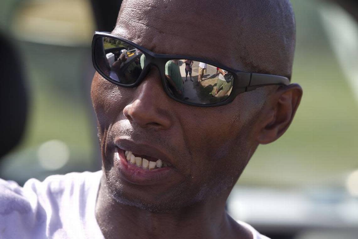 Rodney Hines of Raleigh, N.C, the “No-Hand King,” takes a break after cramping in his legs forced him to stop his trek from Nags Head to Buxton along NC 12 on Tuesday June 16, 2015. Robert Willett / rwillett@newsobserver.com