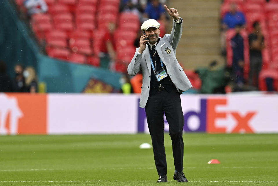 Italy delegation chief Gianluca Vialli gestures while walking on the pitch prior the start of the Euro 2020 soccer championship final match between England and Italy at Wembley Stadium in London, Sunday, July 11, 2021. (Paul Ellis/Pool via AP)