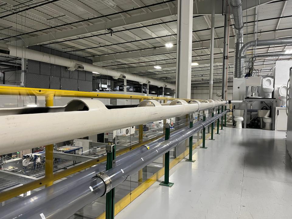 Toilets and clear pipes are used in tests at Kimberly-Clark's Flushability Lab in Neenah, Wisc.