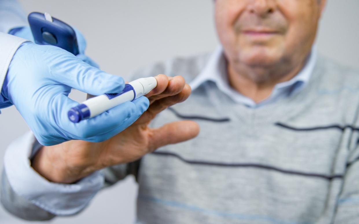 Doctor Checks a man's Blood Sugar Level