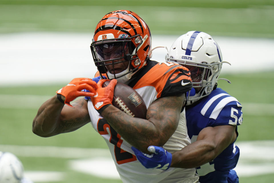 Cincinnati Bengals' Joe Mixon (28) is tackled by Indianapolis Colts' Anthony Walker (54) during the first half of an NFL football game, Sunday, Oct. 18, 2020, in Indianapolis. (AP Photo/AJ Mast)