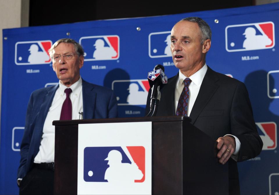 The lockout announced by MLB commissioner Rob Manfred (on right) is the first work stoppage in baseball since 1994, when former commissioner Bud Selig (on left) led the league.