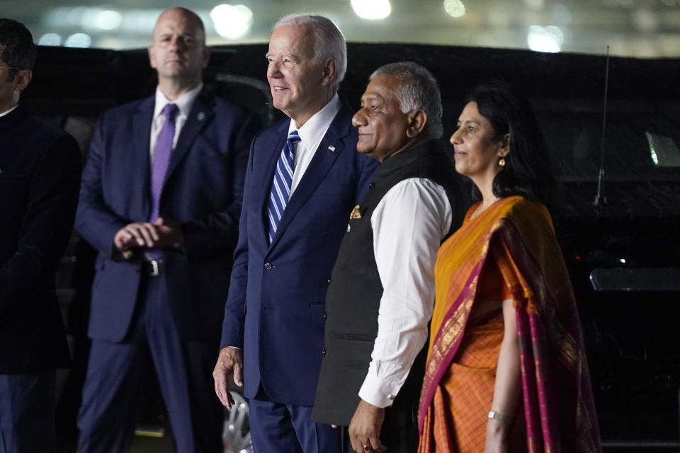 President Joe Biden watches a group of dancers with Vani Sarraju Rao, Joint Secretary in the Ministry of External Affairs, right, and Vijay Kumar Singh, Minister of State for Road Transport and Highways & Minister of State for Civil Aviation, as he arrives at Indira Gandhi International Airport to attend the G20 summit, Friday, Sept. 8, 2023, in New Delhi. (AP Photo/Evan Vucci)