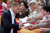 FILE PHOTO: Russian actor Vladimir Mashkov signs autographs as he arrives for the opening of the Moscow Film Festival, Russia June 19, 2008. REUTERS/Sergei Karpukhin/File Photo