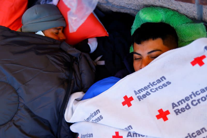 Migrants rest on the day that U.S. President Biden and first lady Jill Biden visit El Paso