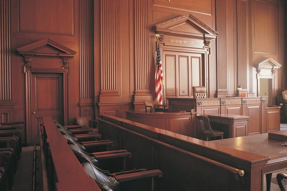 Courtroom as seen from jury box, with wood paneling and furnishings.