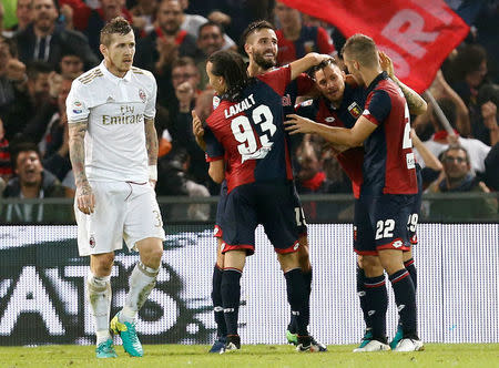 Football Soccer - Genoa v AC Milan - Luigi Ferraris stadium, Genoa Italy- 25/10/16 - Genoa's players celebrate after an own goal scored by AC Milan's Juraj Kucka (L). REUTERS/Alessandro Garofalo