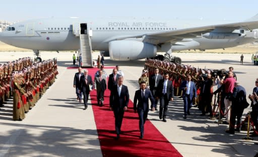 Britain's Prince William and Jordanian Crown Prince Hussein bin Abdullah walk along the red carpet at Amman's Marka military airport at the start of William's tour of the region on June 24, 2018