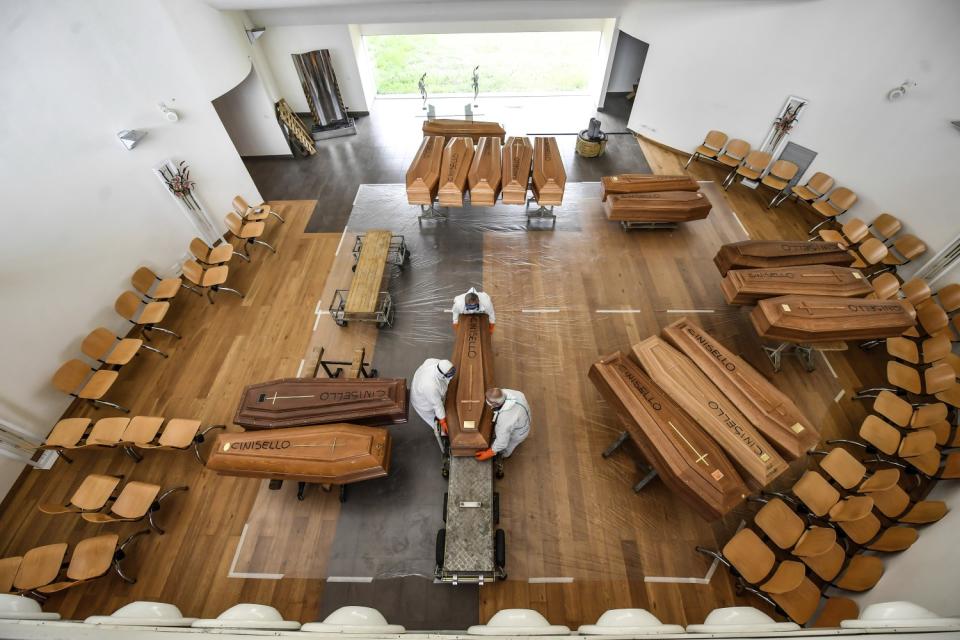 ITALY: Coffins arriving from the Bergamo area, where COVID-19 has claimed many lives, are unloaded from a military truck at the cemetery of Cinisello Balsamo, near Milan in northern Italy.