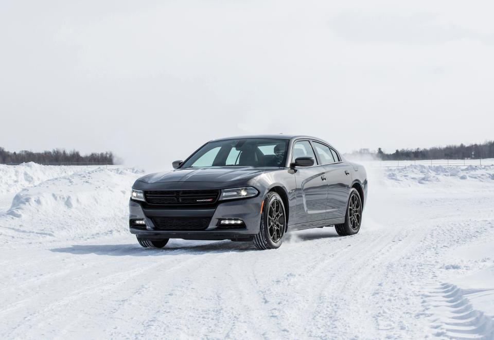 A gray Dodge Charger on a snow-covered road.