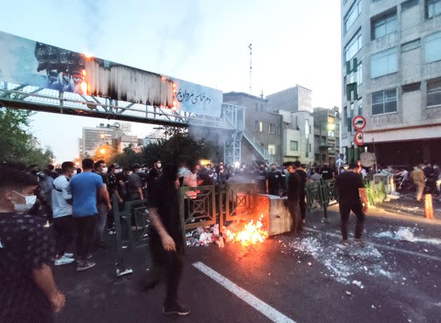 A picture obtained by AFP outside Iran on Sept. 21 shows Iranian demonstrators burning a rubbish bin in the capital Tehran during a protest for Mahsa Amini, days after she died in police custody. (Photo: AFP via Getty Images)