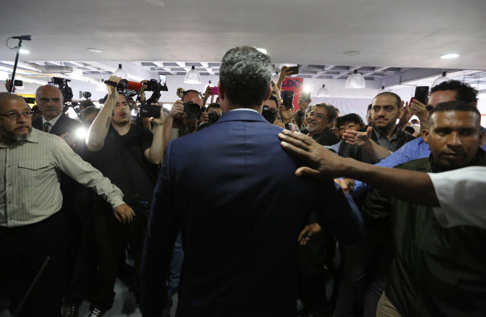 Supporters of Venezuela's opposition leader and self-proclaimed interim president Juan Guaido greet him as he arrives to give a press conference concerning the previous night's arrest of an opposition lawmaker in Caracas, Venezuela, Thursday, May 9, 2019. The arrest of Edgar Zambrano, vice president of the opposition-controlled National Assembly, appeared to be part of a carefully calibrated crackdown on the opposition by President Nicolas Maduro's government. (AP Photo/Fernando Llano)