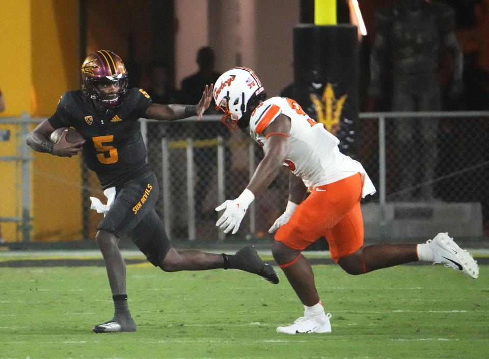 Arizona State Sun Devils quarterback Jaden Rashada (5) is chased by Oklahoma State Cowboys defensive end Jaleel Johnson (95) in the second half at Mountain America Stadium in Tempe on Sept. 9, 2023.