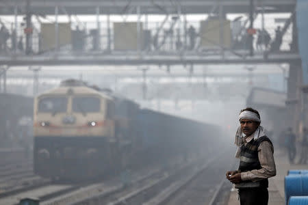 A man stands on railway platform on a smoggy morning in New Delhi, November 10, 2017. REUTERS/Saumya Khandelwal