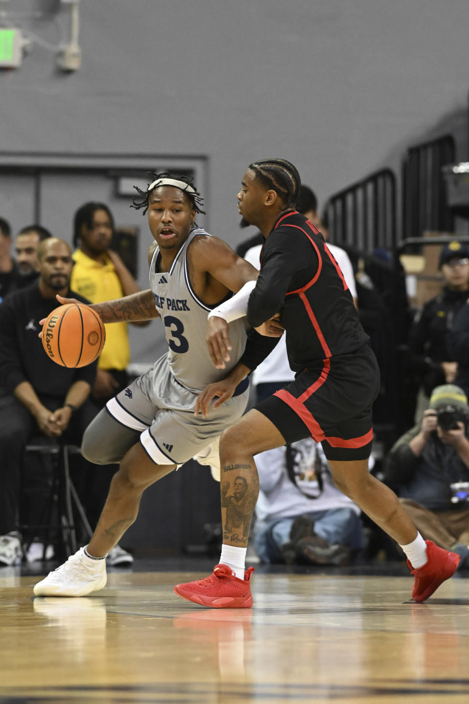 Nevada's Kenan Blackshear dribbles the ball next to San Diego State's Reese Waters during the first half of an NCAA college basketball game Friday, Feb. 9, 2024, in Reno, Nev. (AP Photo/Andy Barron)