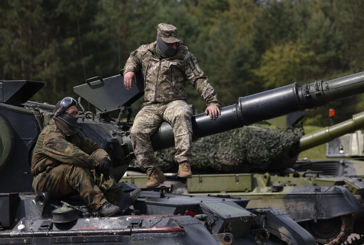 A Ukrainian tank crew relax on the Leopard 1A5 main battle tank they are being trained to operate and maintain by German and Danish military personnel at a military training ground in Germany (Getty Images)