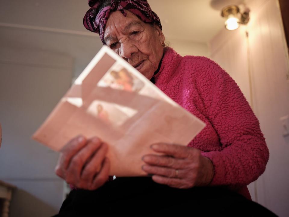 Doña Amalia reads some of the family's immigration paperwork.