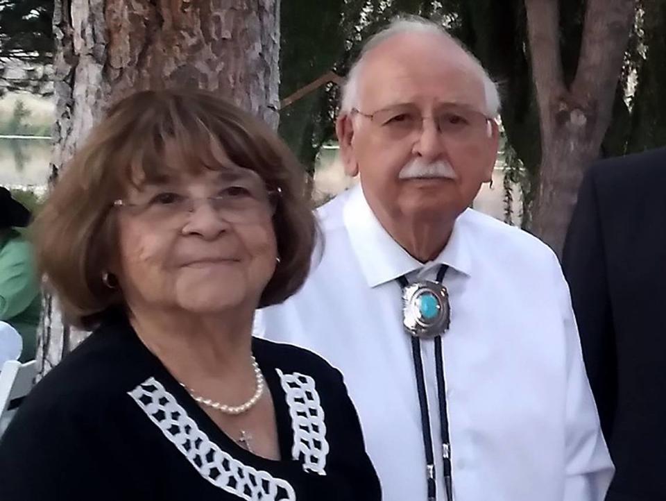 Lillian and Ernesto Parra pose at a family gathering before their home was destroyed by arson.