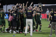 Portland Timbers players celebrate after defeating Orlando City 2-1, during an MLS soccer tournament, Tuesday, Aug. 11, 2020, in Kissimmee, Fla. (AP Photo/John Raoux)