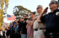 <p>Emergency personnel and residents salute as a procession of firefighting vehicles passes through Santa Paula, while carrying the body of a fellow firefighter who was killed today battling the Thomas wildfire near Fillmore, Calif., Dec. 14, 2017. (Photo: Gene Blevins/Reuters) </p>