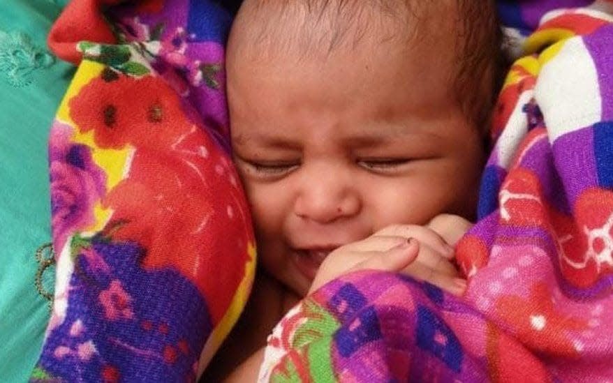 The baby girl wrapped in a blanket - ANIL KUMAR / BBC