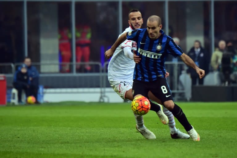 Inter Milan's forward from Argentina Rodrigo Palacio (right) vies with Carpi's defender from Italy Emanuele Suagher during their Italian Serie A match at San Siro Stadium in Milan on January 24, 2016