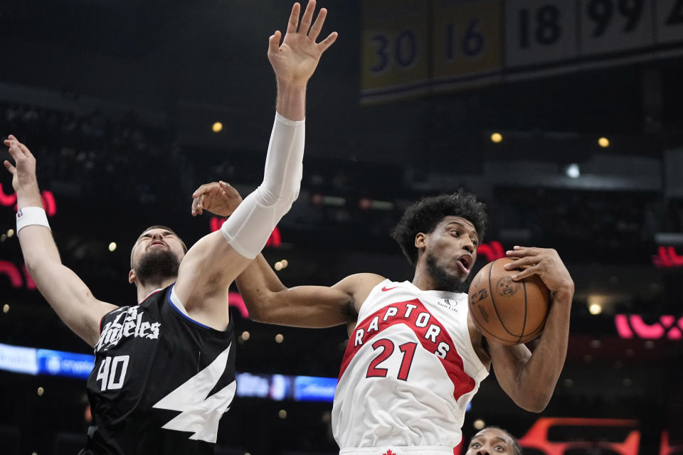 Toronto Raptors forward Thaddeus Young, right, grabs a rebound away from Los Angeles Clippers center Ivica Zubac during the second half of an NBA basketball game Wednesday, Jan. 10, 2024, in Los Angeles. (AP Photo/Mark J. Terrill)