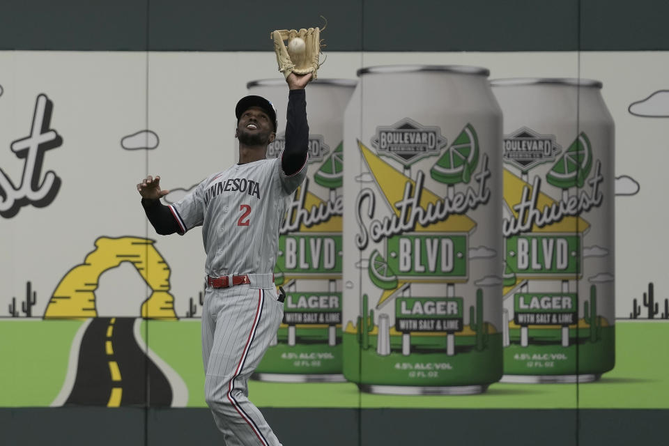 Minnesota Twins center fielder Michael A. Taylor catches a fly ball for the out on Kansas City Royals' Bobby Witt Jr. during the first inning of an opening day baseball game in Kansas City, Mo., Thursday, March 30, 2023. (AP Photo/Charlie Riedel)