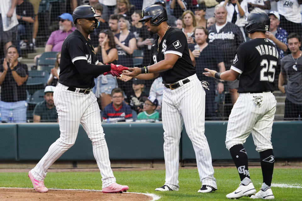 Chicago White Sox's Eloy Jimenez, left, celebrates with Jose Abreu, center, and Andrew Vaughn after hitting a three-run home run during the first inning of a baseball game against the Minnesota Twins in Chicago, Saturday, Sept. 3, 2022. (AP Photo/Nam Y. Huh)