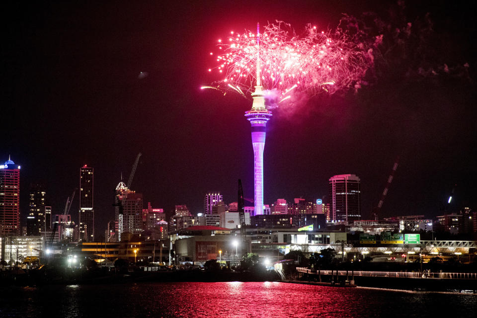 Fireworks explode over Sky Tower in central Auckland as New Year celebrations begin in New Zealand, Sunday, Jan. 1, 2023. (Dean Purcel/NZ Herald via AP)