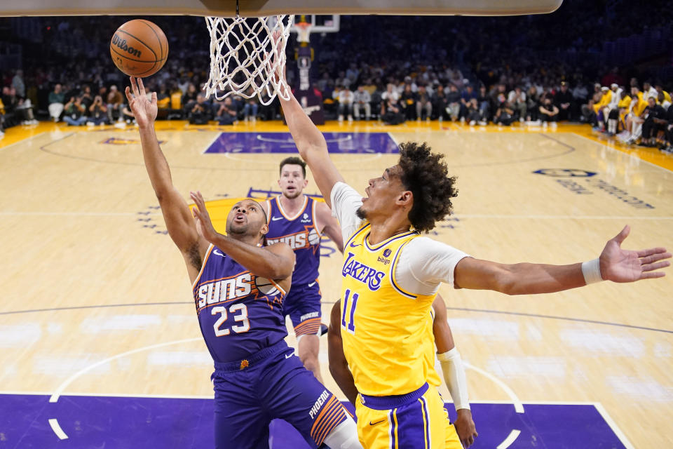 Phoenix Suns guard Eric Gordon, left, shoots as Los Angeles Lakers center Jaxson Hayes defends during the first half of an NBA basketball game Thursday, Oct. 26, 2023, in Los Angeles. (AP Photo/Mark J. Terrill)
