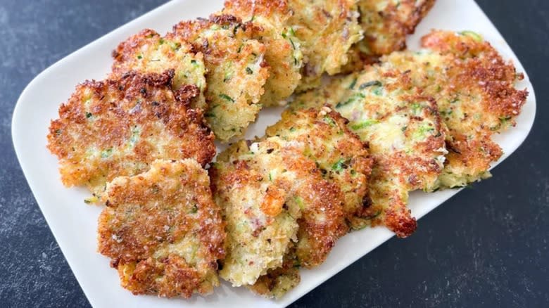 Zucchini fritters on white platter