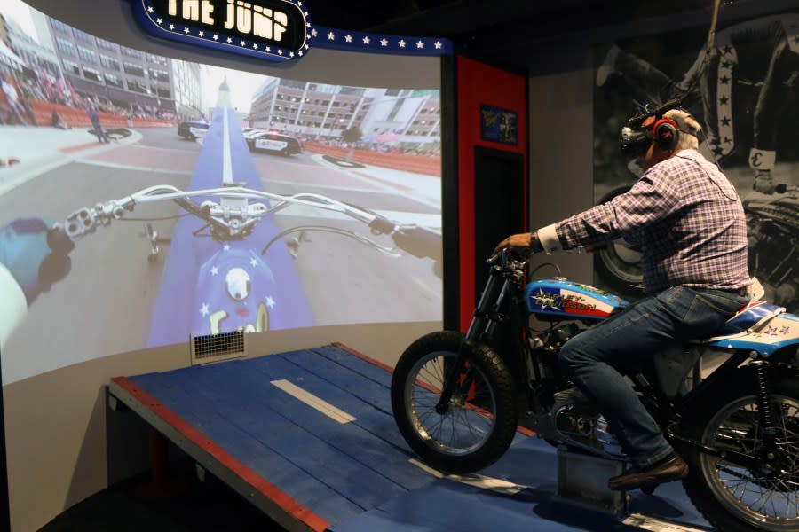 Ron Pope jumps on a motorcycle over a group of police cars– via virtual reality– at the Evel Knievel Museum in Topeka, Kansas on June 21, 2017. (Photo credit should read BETH LIPOFF/AFP via Getty Images)