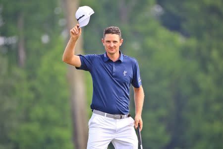 Apr 26, 2015; Avondale, LA, USA; Justin Rose tips his hat to the crowd in celebration after sinking a birdie on the 18th green during the final round of the Zurich Classic at TPC Louisiana. Derick E. Hingle-USA TODAY Sports