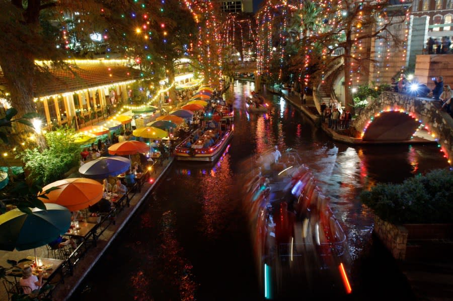 Carolers sing a Christmas song as they ride a barge on the San Antonio River under holiday lights on the Riverwalk in downtown San Antonio, Wednesday, Dec. 3, 2008. (AP Photo/Eric Gay)