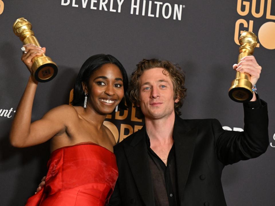 Edebiri and White holding aloft their Golden Globes earlier this month (AFP via Getty Images)