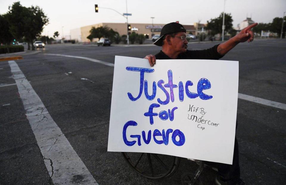 Gary Mancillas carries a sign in support of Jose Valencia Pulido, nicknamed Guero, during a vigil Friday evening, Sept. 25, 2020 at the corner of E Street and Fresno Street. Pulido was killed Sept 5 after being reportedly struck by a car driven by an on-duty Fresno Police detective.