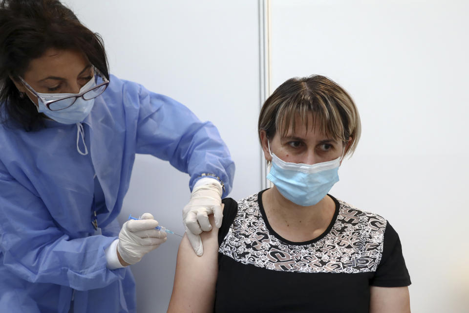 A woman gets a COVID-19 vaccine in Sarajevo, Bosnia, Saturday, Sept. 25, 2021. Public mistrust of authorities in corruption-plagued Bosnia has created an opening for anti-vaccination movement even though the Balkan nation has the highest rate in Europe of coronavirus deaths and faces a growing number of new infections. So far, despite an abundance of coronavirus vaccines in Bosnia, just under 13 percent of its 3.3 million people had been fully immunized against Covid-19. (AP Photo)