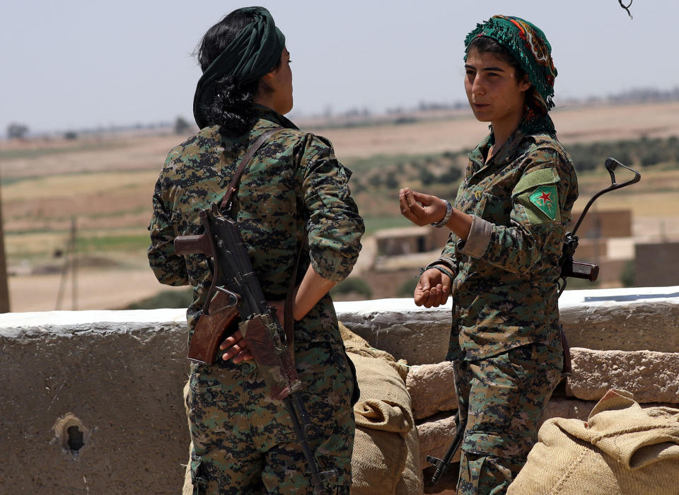 <p>Fighters from the Kurdish People’s Protection Units (YPG) stand atop a building at the eastern outskirts of Raqqa city, Syria June 7, 2017. Picture taken June 7, 2017. (Photo: Rodi Said/Reuters) </p>