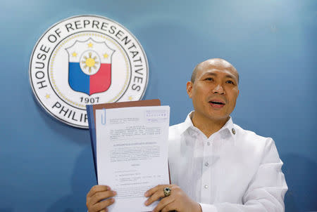 Magdalo Partylist Congressman Gary Alejano shows to the media a copy of a supplemental impeachment complaint against President Rodrigo Duterte during a news conference at the House of Representatives in Quezon city, Metro Manila in the Philippines March 30, 2017. REUTERS/Erik De Castro