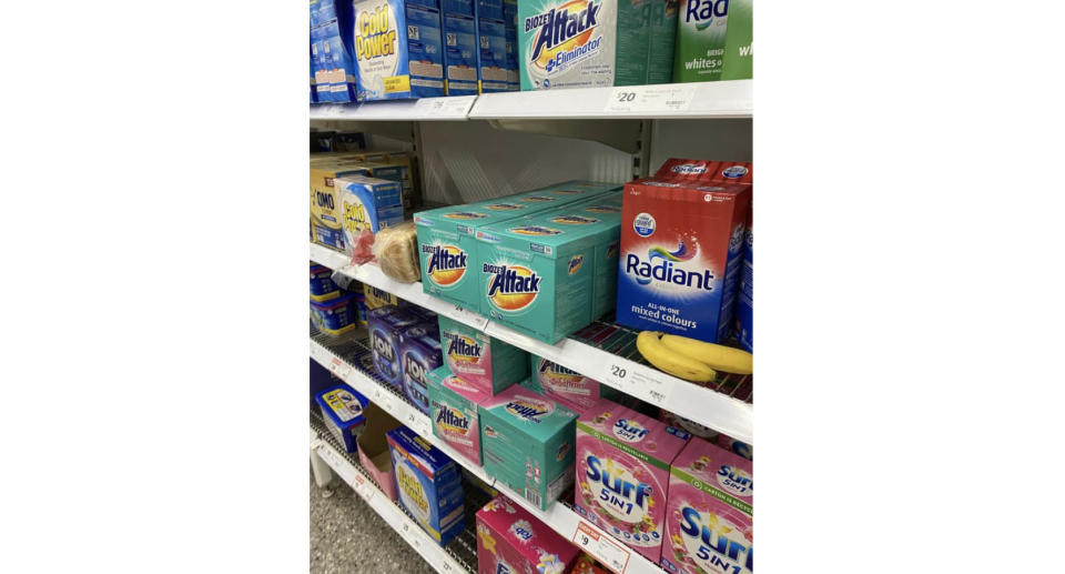 The shelf in Coles with the bananas and loaf of bread. 