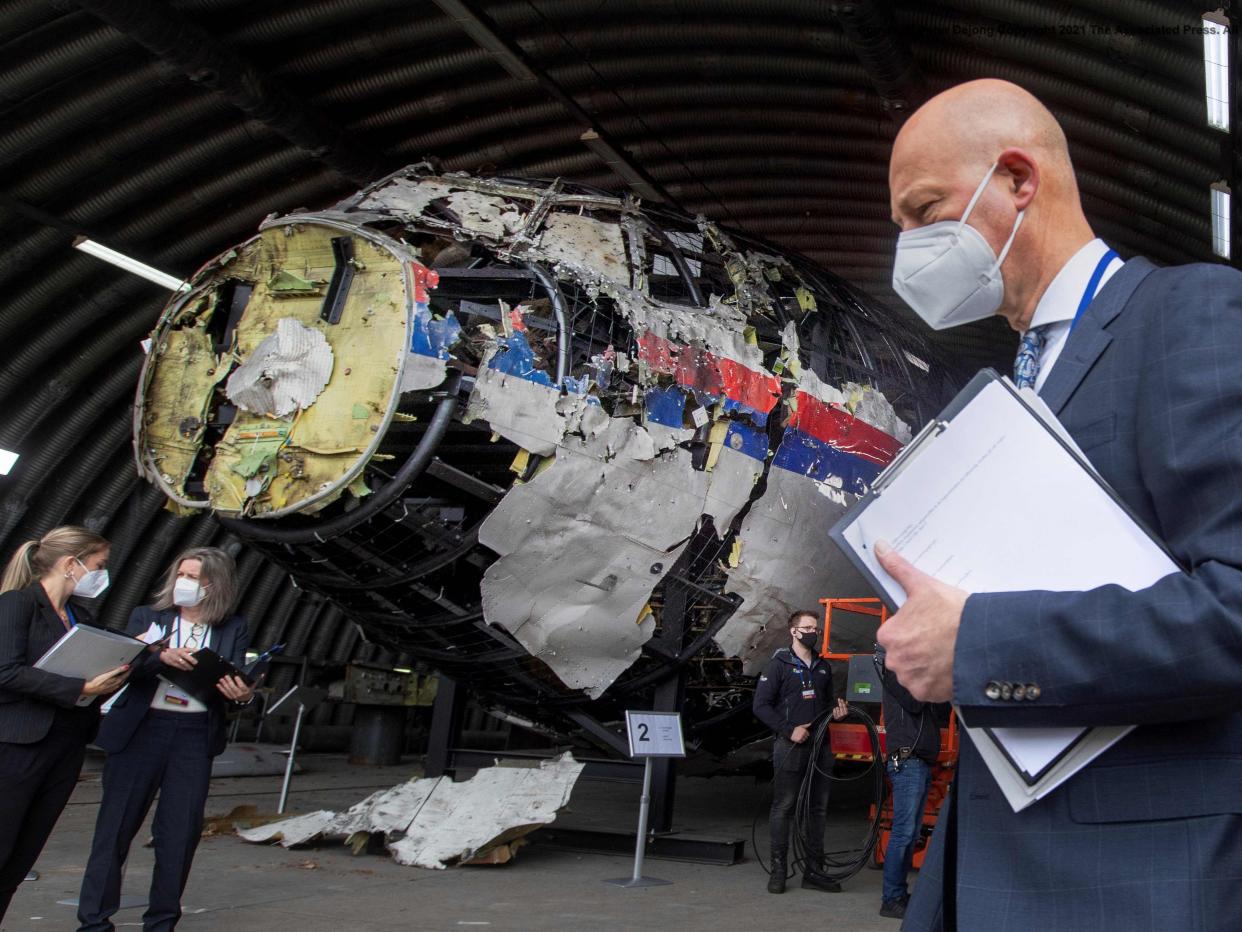 <p>Hendrik Steenhuis views the reconstructed wreckage of Malaysia Airlines Flight MH17 at the Gilze-Rijen military airbase on 26 May 2021</p> (AFP/Getty)
