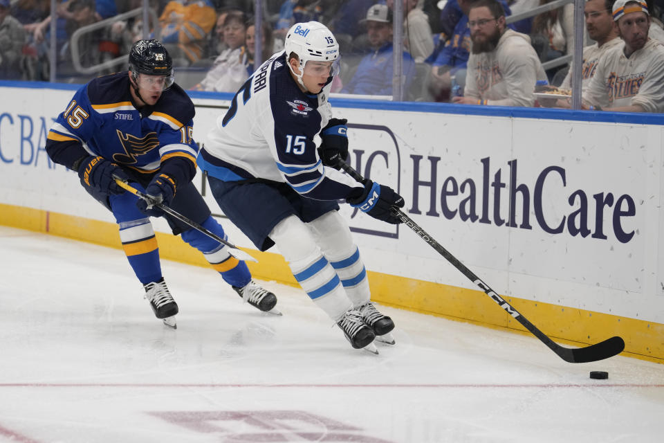 Winnipeg Jets' Rasmus Kupari, right, and St. Louis Blues' Jakub Vrana chase after a loose puck along the boards during the third period of an NHL hockey game Tuesday, Nov. 7, 2023, in St. Louis. (AP Photo/Jeff Roberson)