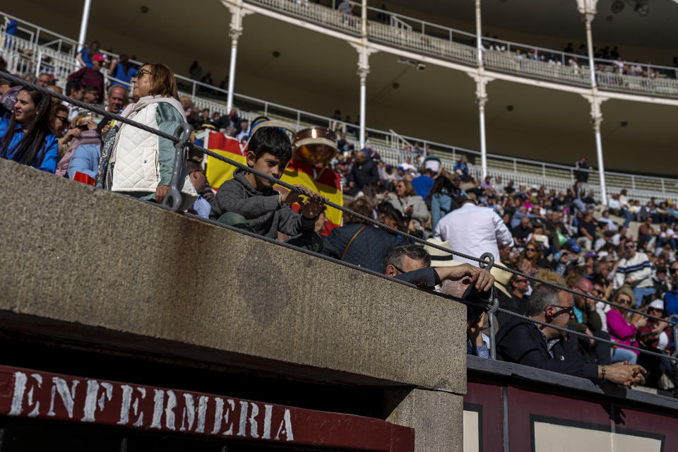 A child waits for the bullfight to begin at Las Ventas bullring in Madrid, Spain, Sunday, March 26, 2023. Just under 2% of Spaniards attended a bullfight in the 2021-22 season, according to Culture Ministry statistics, but among them teenagers aged 15-19 were the largest group. (AP Photo/Manu Fernandez)
