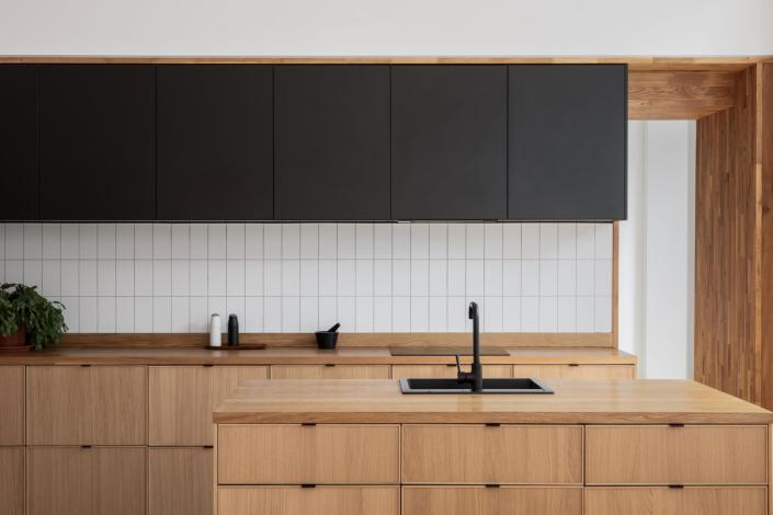 Clean and sleek metro tiles elevate the IKEA cabinetry in this Edinburgh kitchen by Luke McClelland.