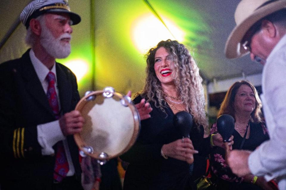 Diana Lara Smart (middle), singer, dances during the launch of the Celia Cruz Forever exhibit at Tower Theatre Miami on Thursday, July 27, 2023 in Miami, Fla.