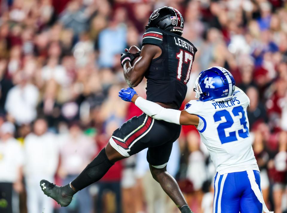 Nov 18, 2023; Columbia, South Carolina, USA; South Carolina Gamecocks wide receiver Xavier Legette (17) makes a touchdown reception over Kentucky Wildcats defensive back Andru Phillips (23) in the second half at Williams-Brice Stadium. Mandatory Credit: Jeff Blake-USA TODAY Sports Kentucky